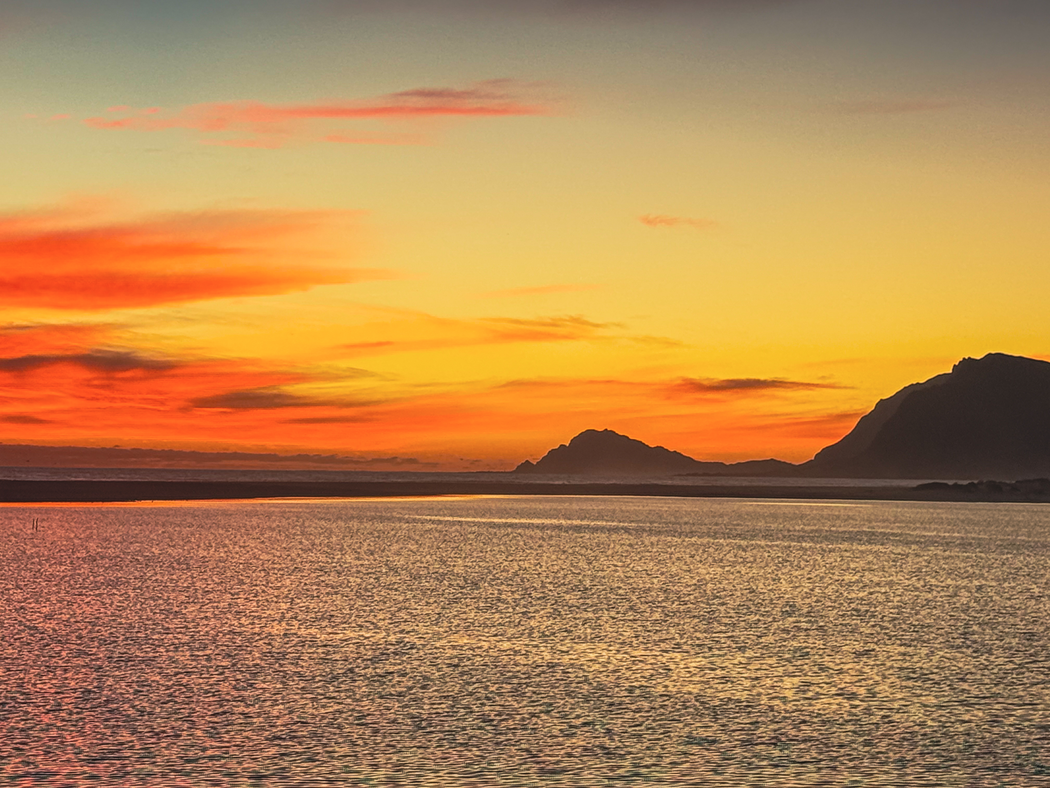 Vivid orange and red sunset over the Kleinrivier Lagoon at Fisherhaven — the evening sky that ends every day at MBIZI lagoon house