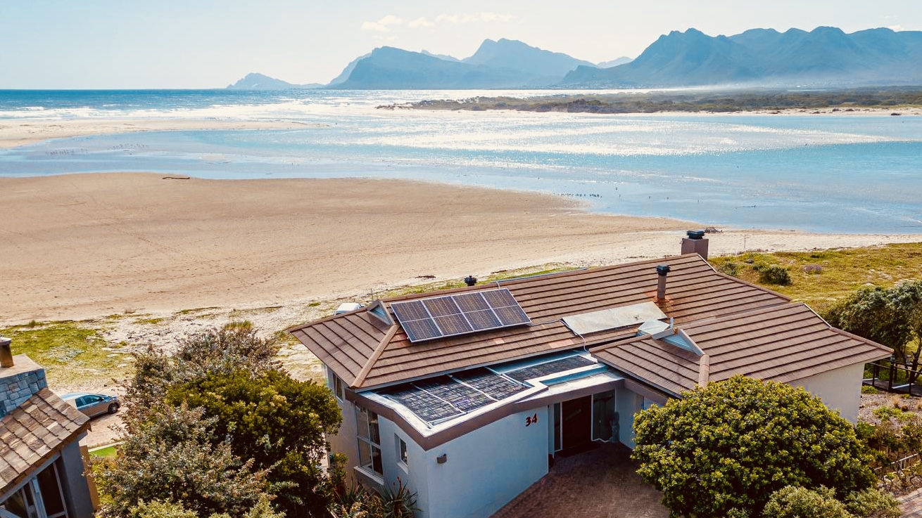 Aerial view of MBIZI lagoon house in Fisherhaven directly on the Kleinrivier Lagoon with Overberg mountains behind — 12 km from the Hermanus cliff path