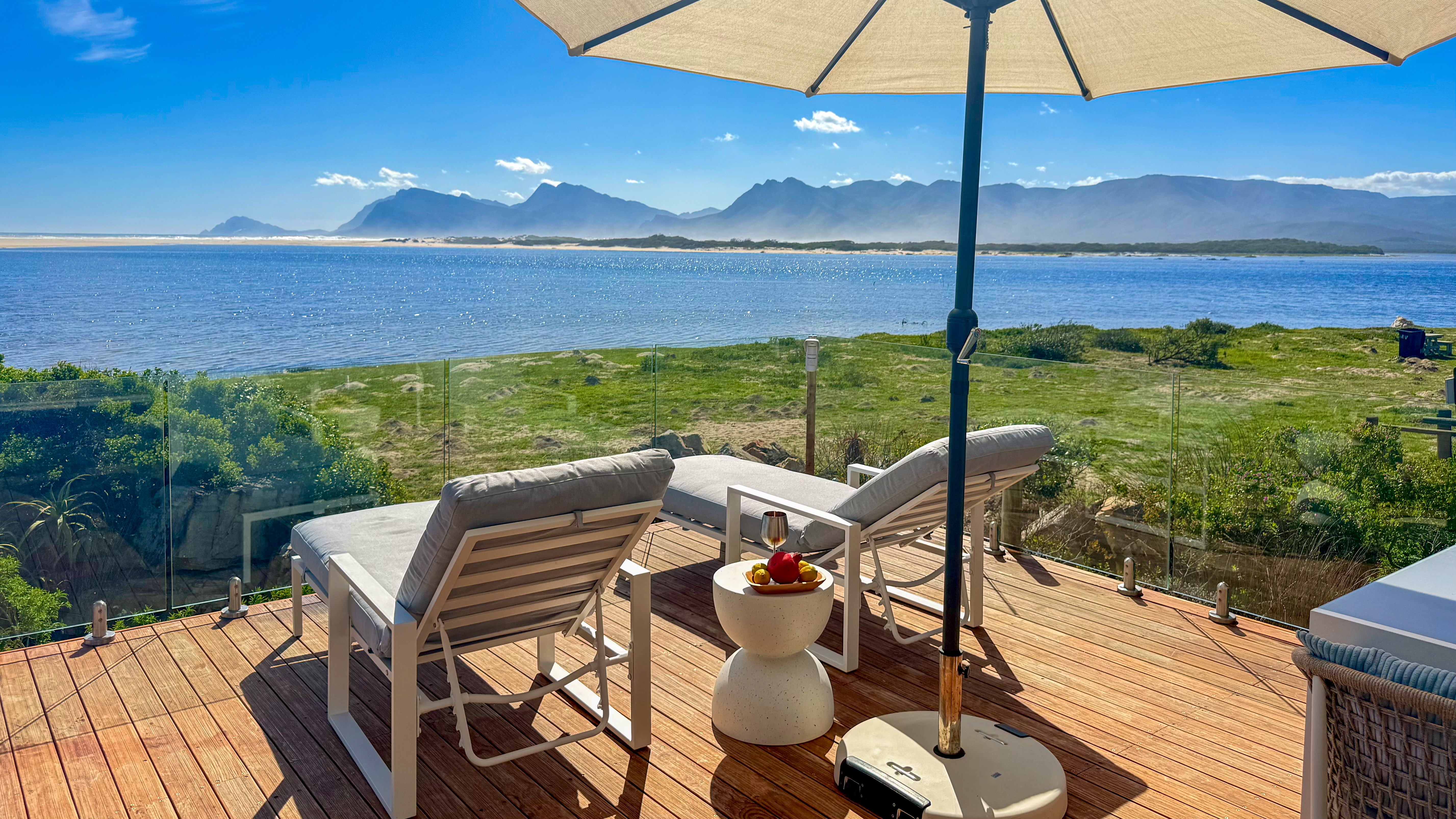 The terrace at MBIZI lagoon house looking directly across the Kleinrivier Lagoon towards Walker Bay — the ideal vantage point for whale watching in Hermanus
